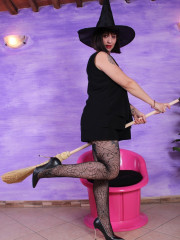 Drop-dead gorgeous Ammalia as a sexy witch flashes her legs in black patterned pantyhose