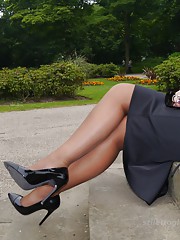 MILF Karen rposes outdoors and shows her legs in a silky nylons and a tall shiny pair of black high heeled shoes